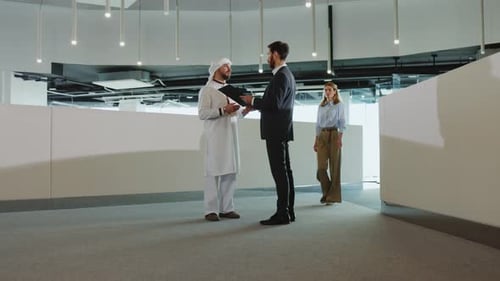 Caucasian and Arabian Business Colleagues Meeting in International Office Center Discussing