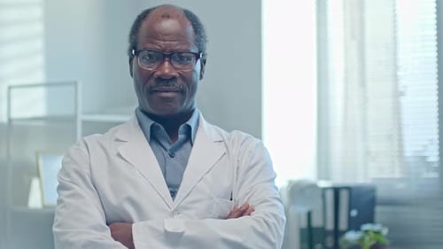 Portrait of Senior General Practitioner at Work in Clinic