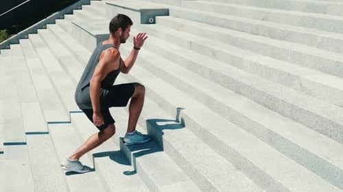 Athletic Man Exercising on Urban Stairs Outdoors