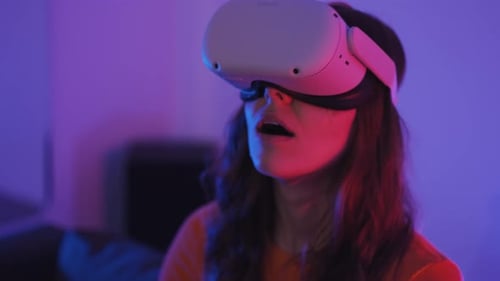 Woman Using Virtual Reality Headset with Neon Lighting