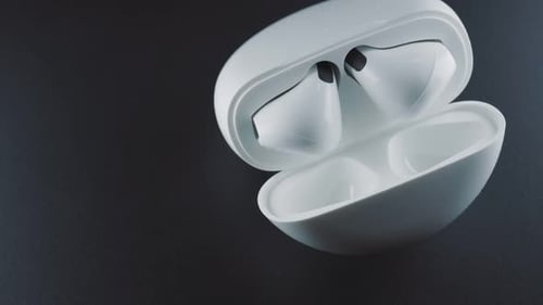 Wireless Earbuds in Charging Case on Dark Surface