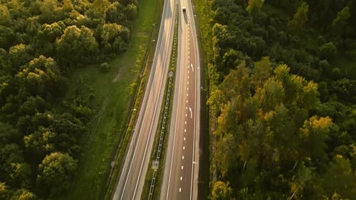 Experience the Beauty of a Forest Highway From Above at Sunset Offering a Peaceful Landscape for a