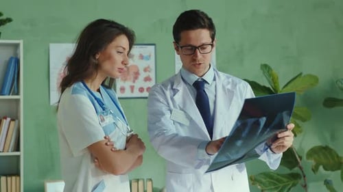 Team of Medical Workers Cooperating in the Private Clinic Office Doctor and Nurse Discussing Therapy