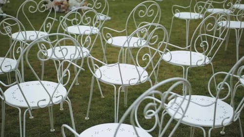 Rows of White Chairs on Green Lawn for Wedding