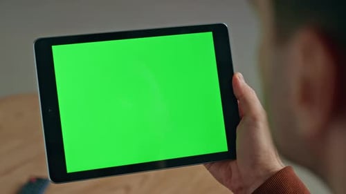Adult Holding Tablet with Green Screen Display