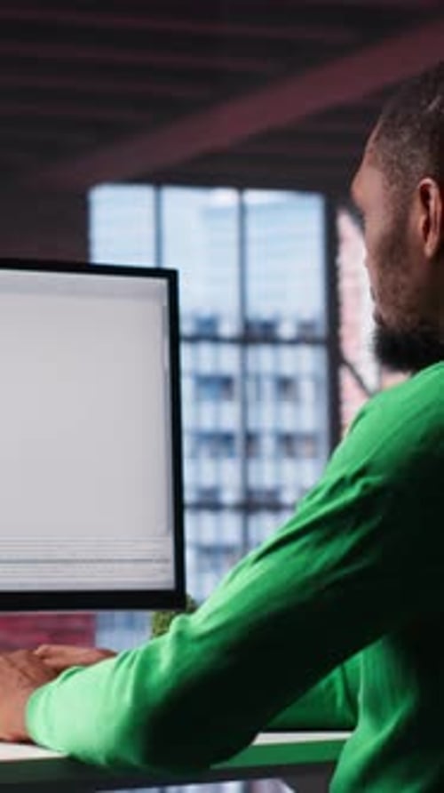 Vertical Video Black IT Expert Looking at User Interface on Computer at Home Office