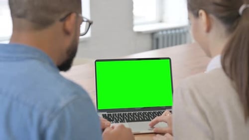 Rear View of Young People Using Laptop with Green Screen