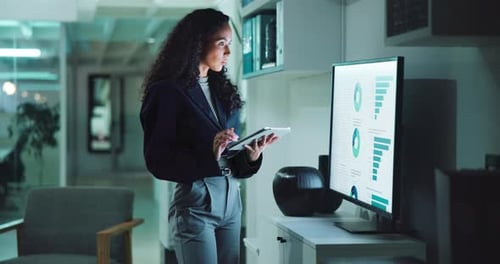 Business Woman Analyzes Data at Night in Office