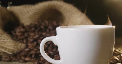 Top view of a cup of Italian coffee on the wooden backdrop with coffee beans to be grinded. Excell