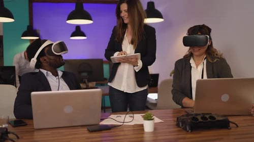 Workers Using VR Headsets in a Modern Office