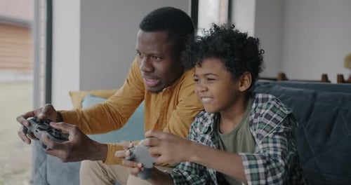 Happy Father and Son Playing Video Games Together