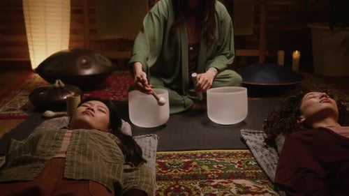 Multiethnic Women Meditating during Sound Healing with Singing Bowls