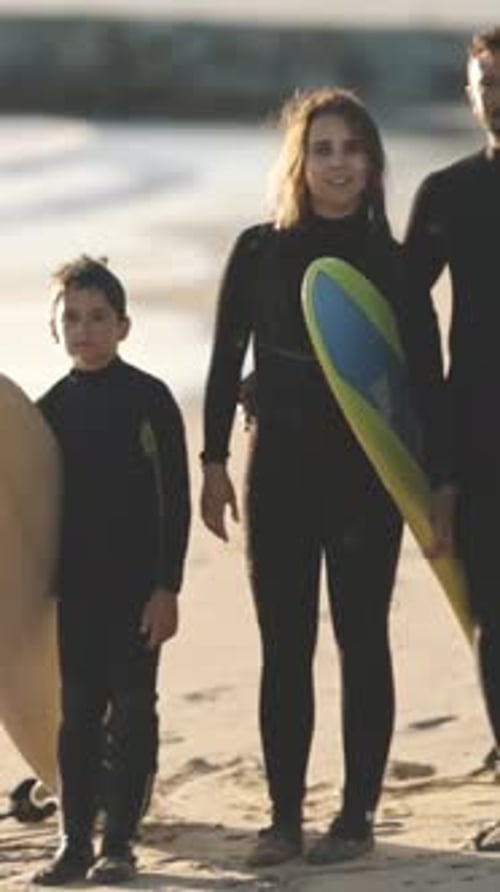 A Family of Surfers Go to the Sea with Boards