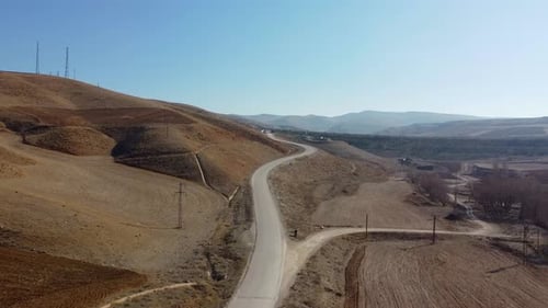 Winding Road Through Brown Hills Aerial View