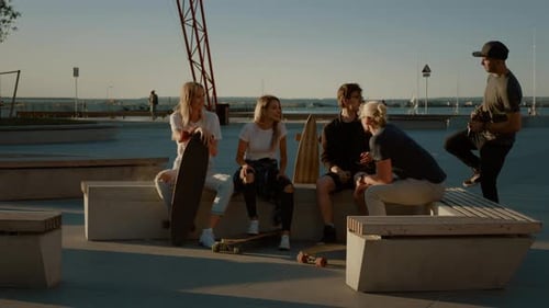 Group of Stylish Girls and Boys Drinking Craft Drinks on the Park Bench in the Cool Hipster City Di