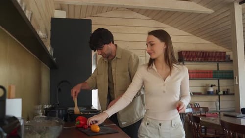 Couple Cooking and Dancing Together in Kitchen
