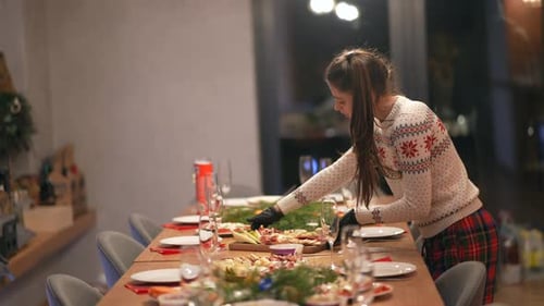 Woman Prepares Festive Holiday Dinner Table