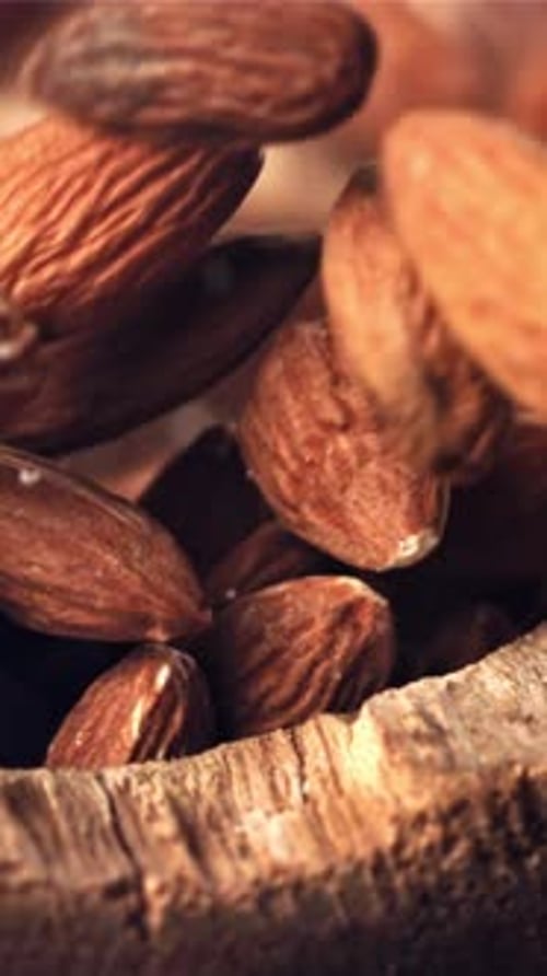 Almond Drops Wooden Bowl Filmed on a Highspeed Camera at 1000 Fps