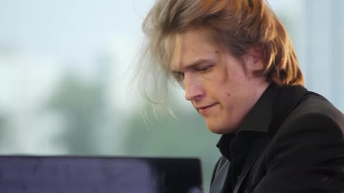 Young Adult Playing Piano in Concert Hall