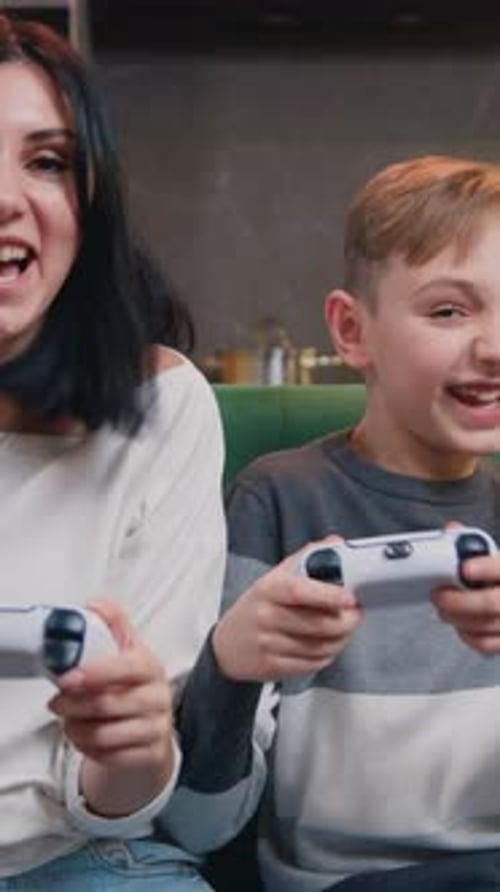 Cheerful Woman and Boy Playing Video Games at Home