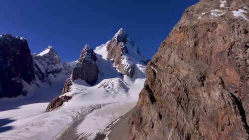 Majestic snow-covered mountain peaks under a clear blue sky