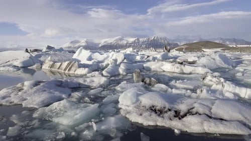 Aerial view of Jokulsarlon glacier lagoon with iceberg floating and mountains
