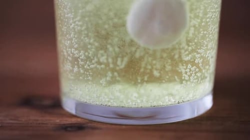 Effervescent Tablet Dissolving in Glass of Water
