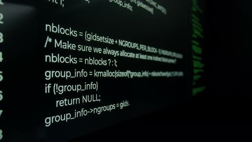 Close-up of Running Code on Monitor Screens