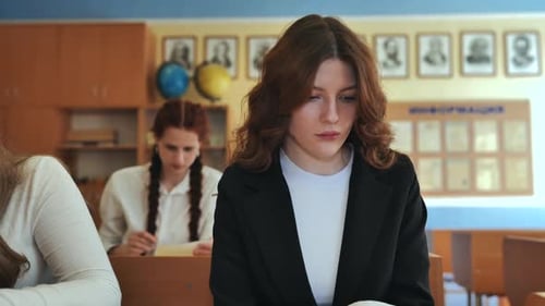 High School Girls at a Desk in the Classroom During Class