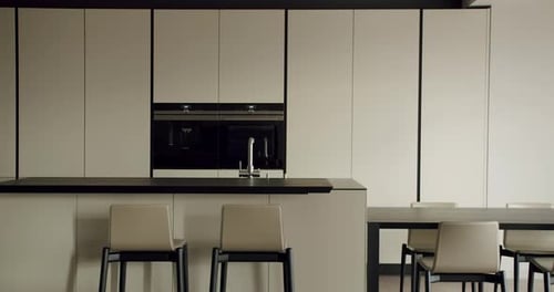 Modern Kitchen Interior with Sleek Cabinets and Stylish Seating