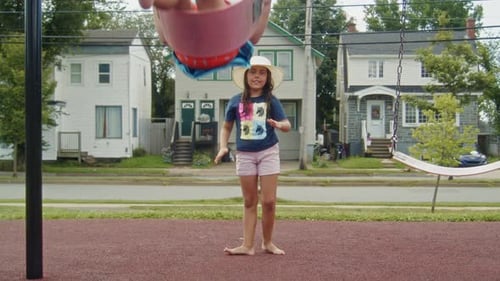 Girl Pushing Boy on Swing at Urban Playground