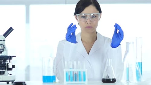 Woman Scientist with Lab Equipment Explains Process
