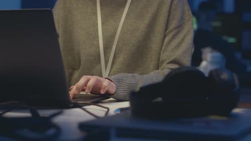 Female Programmer Working on Laptop at Night