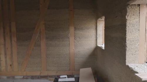 Inside view of a hempcrete wall in wooden frame with windows unter construction