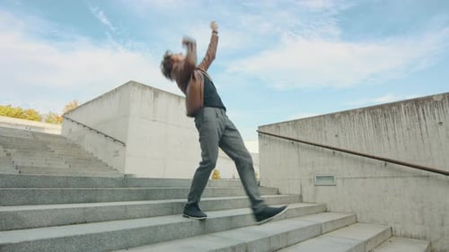 Happy Man Dancing Down Concrete Urban Stairs