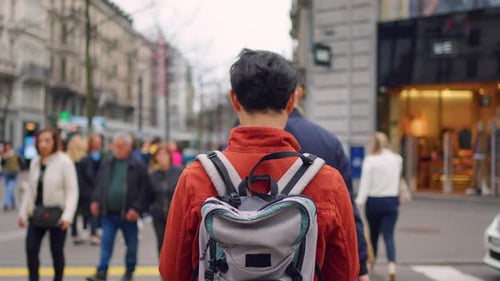 Asian attractive man backpacker walking around beautiful road in city.