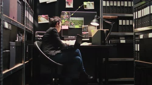 Woman at Desk with Investigation Documents