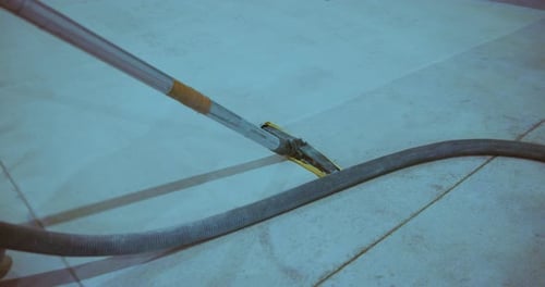 Hard Floor Cleaning. Worker using Industrial Vacuum Cleaner.