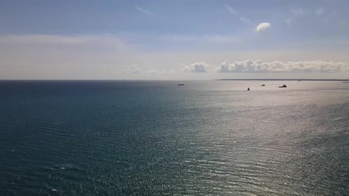 Mediterranean Sea. Camera flight into the horizon line. Sea and sun along the ships.