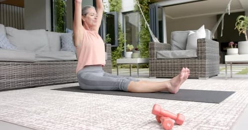 Senior Woman Stretching on a Yoga Mat