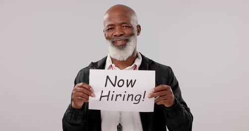 Senior, hiring sign and black man in business, opportunity or interview against a studio background