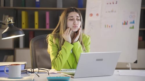 Nervous businesswoman in night office.