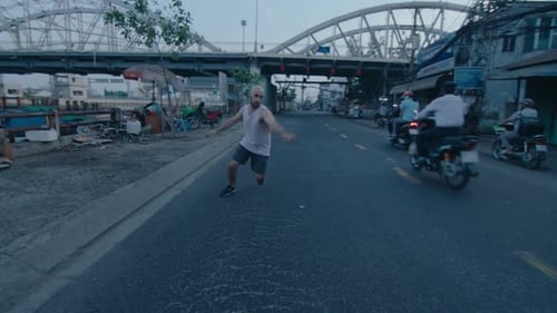 Parkourist Performing Backflip on the Road