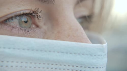 Close-Up Portrait Of Modern Young Nurse Woman Wearing Protective Medical Face Mask And Looking. C...