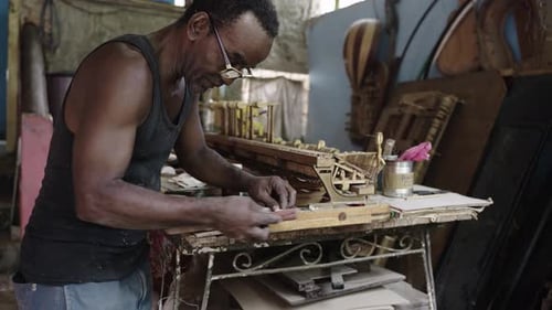 Artisan Luthier Working on Creation of Wooden Piano Making Handmade Musical Instruments in Workshop