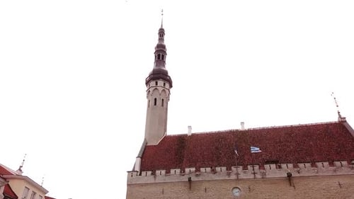 The tower of the Tallinn city town hall hyper lapse in moving circling shot.
