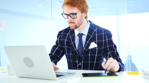 Man Designs with Stylus and Graphics Tablet