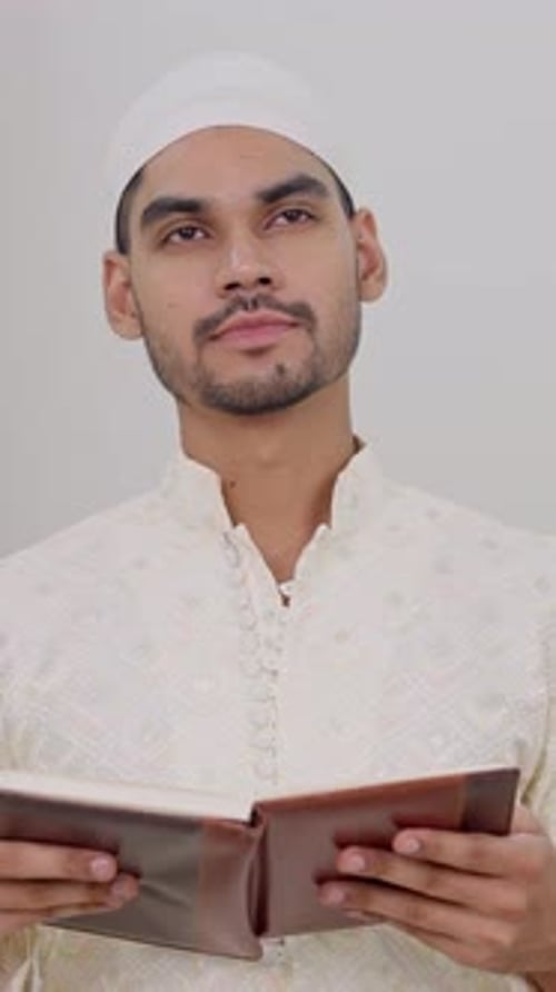 Young Adult Reading Religious Book Indoors