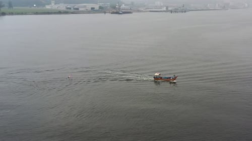 Fisherman dropped fishing net into the sea, traditional fishing boat sailing on the sea out for a mo