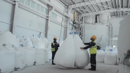 Man And Woman Working In Factory Warehouse